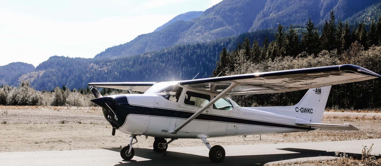 A Cessna 172 parked on a mountain airstrip