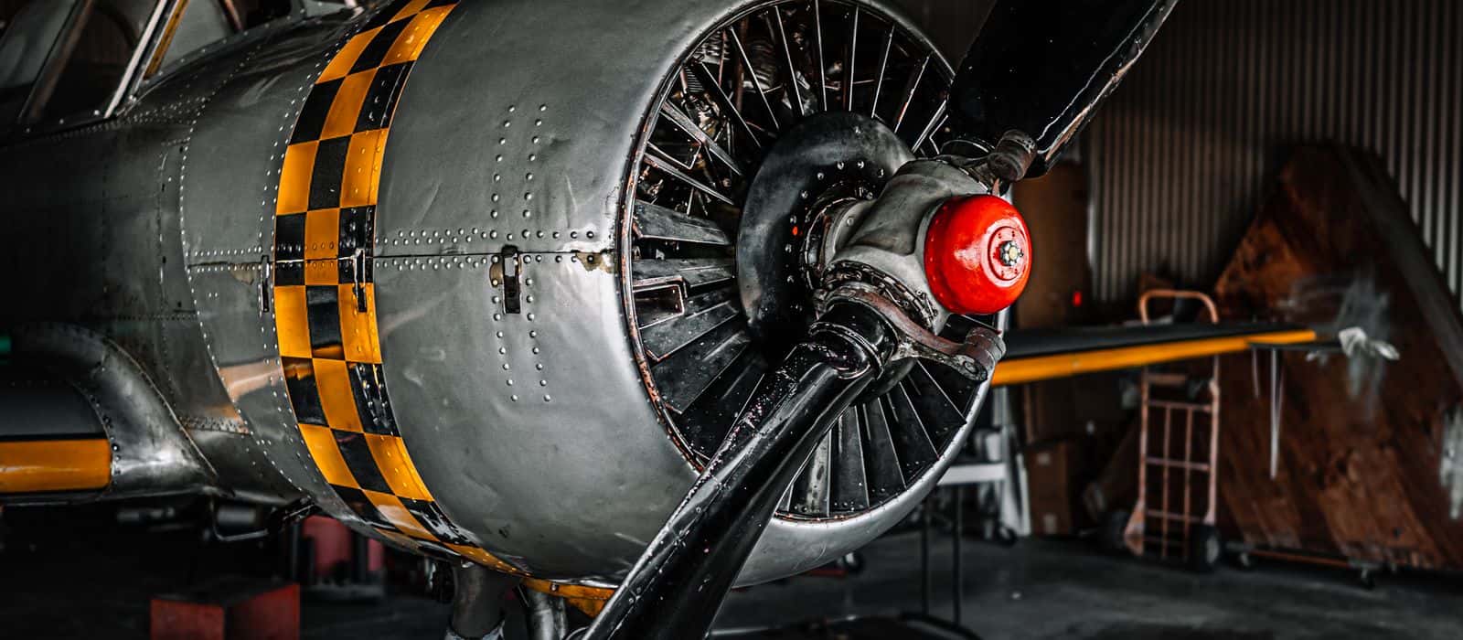 An aircraft engine and propeller under work in a hangar